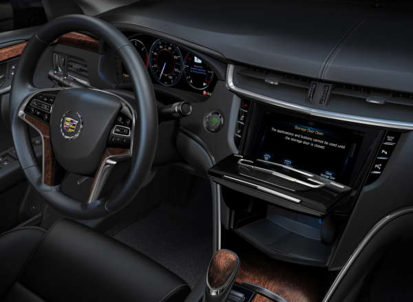 Cadillac CUE integrates interior design with industry-first control and command technologies. It will debut in 2012 in the ATS and XTS luxury sedans and SRX luxury crossover, and features a 1.8 liter storage compartment behind the main system touch screen. The compartment features a USB port and wireless Bluetooth connections for devices and smartphones.