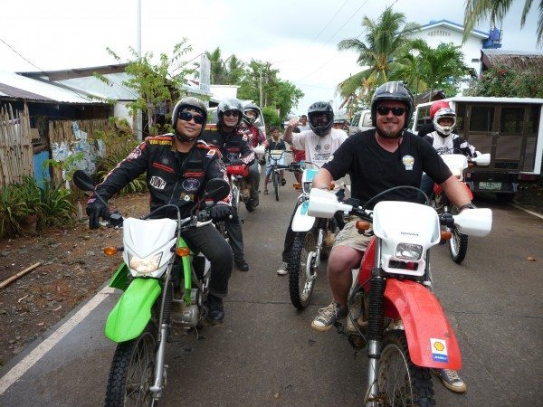 Charley Boorman and a group of local bikers on set filming Freedom Riders Asia in Puerto Princesa Philippines