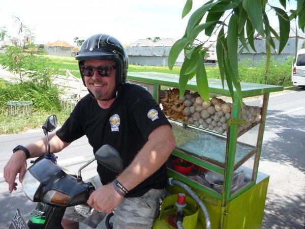 Charley Boorman on a challenge to sell some local Indonesian cuisine on a bike while filming Freedom Riders Asia in Bali