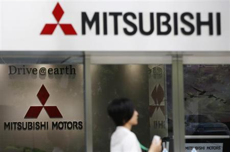 A woman walks in front of Mitsubishi Motors Corp's headquarters in Tokyo