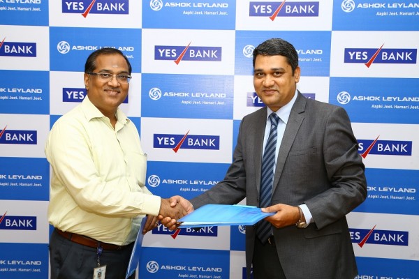 Ramkumar K (Ashok Leyland) and Nipun Jain (YES Bank) signing the MOU