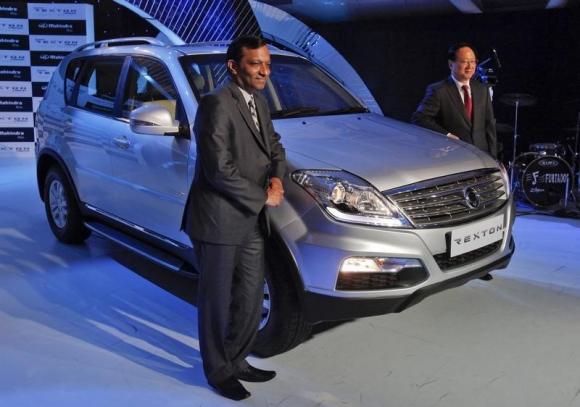 Goenka and Yoo-Il pose with newly-launched Ssangyong Rexton SUV vehicle in Mumbai