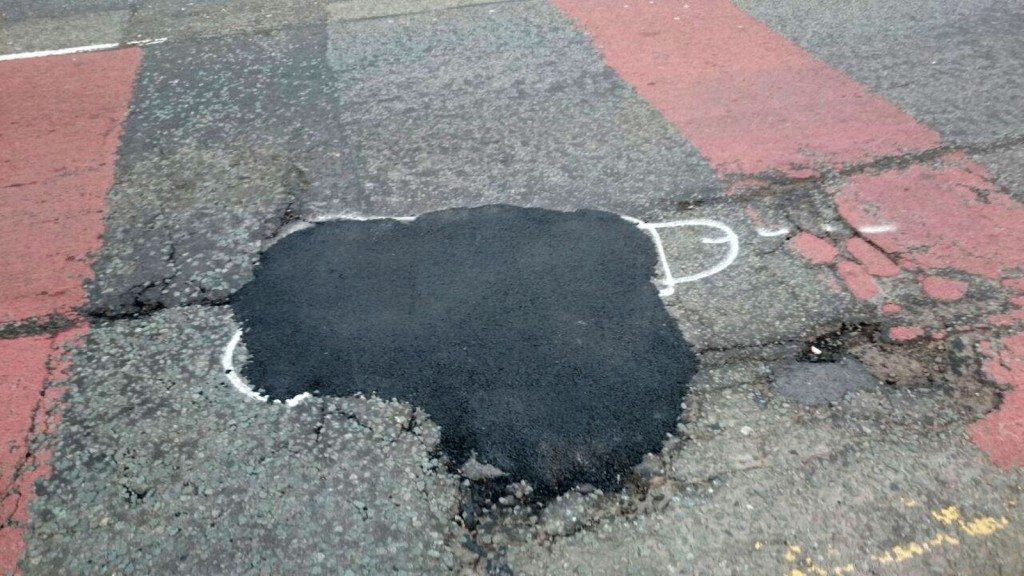 wanksy artist pothole graffiti (2)