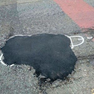 wanksy artist pothole graffiti