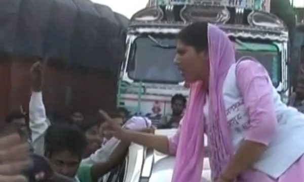 Woman protesting on car