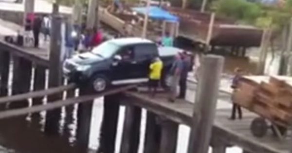 truck boarding a ship over a plank