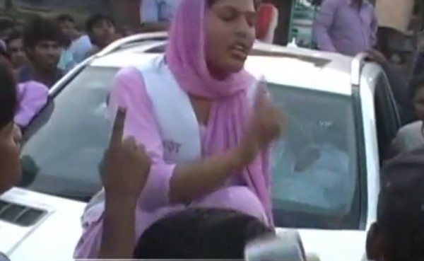 woman protesting atop a merc