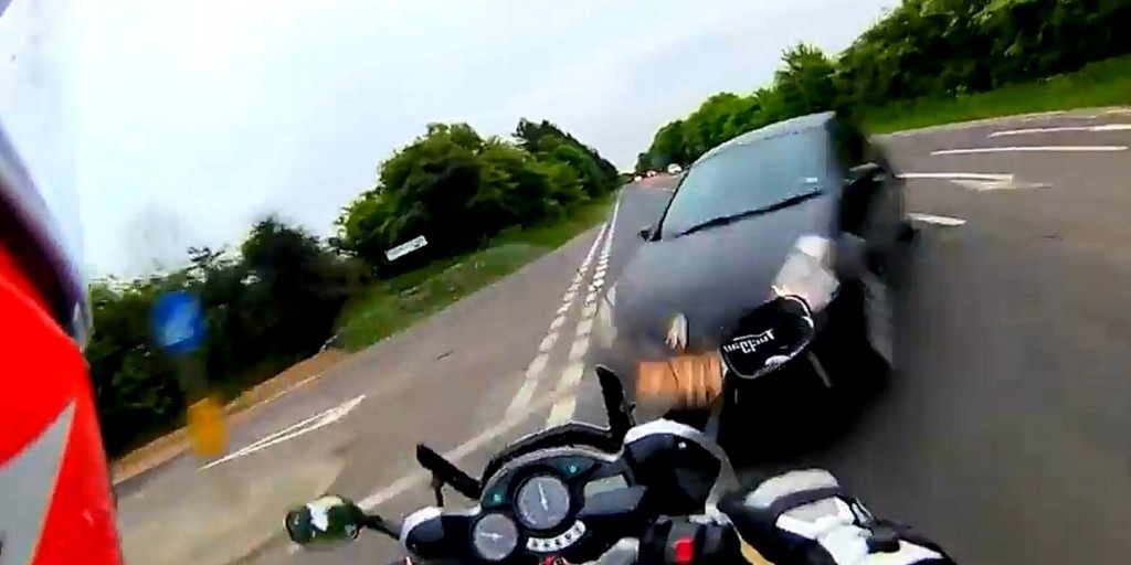 The driver of the car didn't see the biker when he took the turn