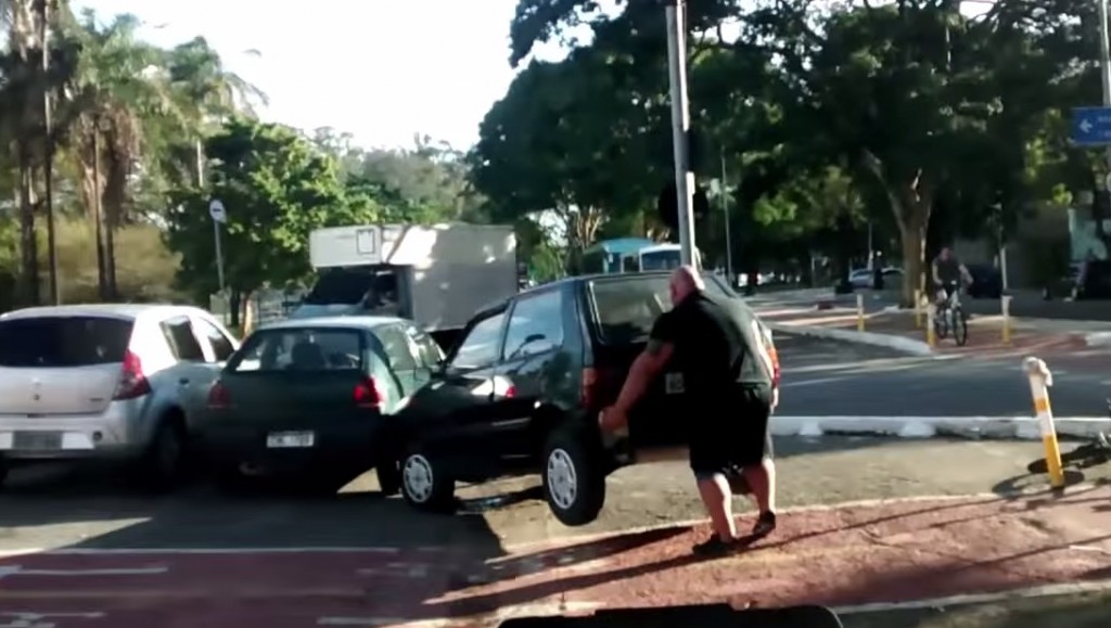 muscle man lifts car in brazil