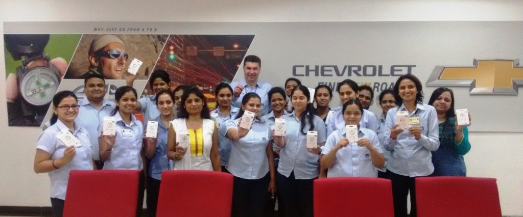 Kaher Kazem, President & MD, GM India giving the SAFER device to the women employees at Talegaon