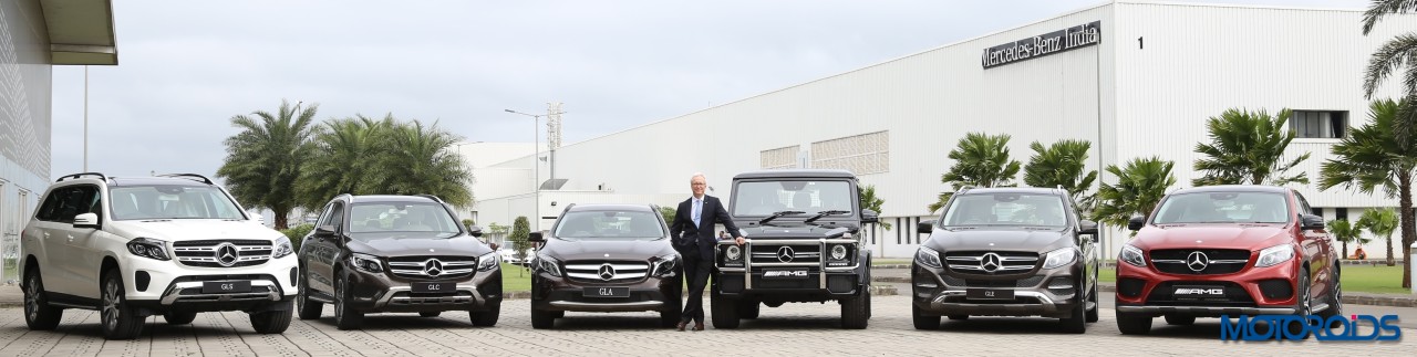 Mr. Roland Folger posing with the entire range of petrol SUVs from Mercedes-Benz