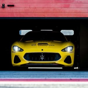 Maserati yellow GT exiting pit