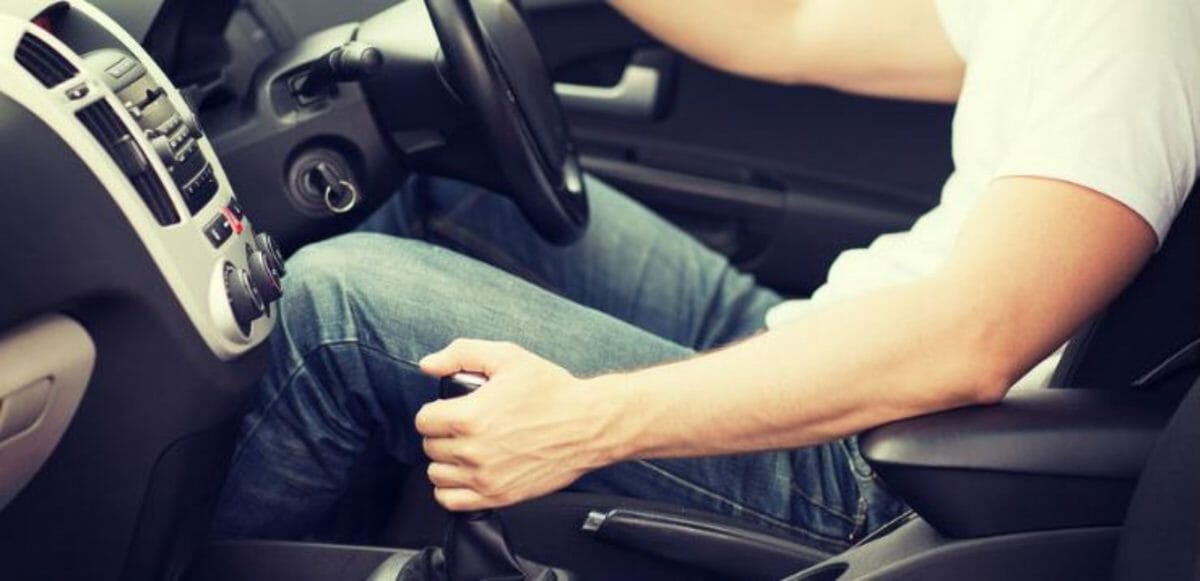 Hand resting on the gear lever